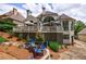 Spacious backyard with a deck, seating area, lush greenery, and attractive landscaping features at 1021 Wetherby Way, Alpharetta, GA 30022
