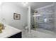 Stylish bathroom featuring a marble walk-in shower, brass fixtures, and hexagon floor tiling at 1021 Wetherby Way, Alpharetta, GA 30022