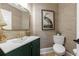 Stylish half bathroom featuring a patterned wallpaper, vanity, and modern fixtures at 1021 Wetherby Way, Alpharetta, GA 30022