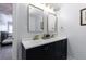 Stylish bathroom with double vanity, gold fixtures, modern mirrors, and matte black cabinets at 1021 Wetherby Way, Alpharetta, GA 30022