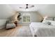 Airy bedroom showcasing hardwood floors, arched window and a cozy sitting area at 1021 Wetherby Way, Alpharetta, GA 30022