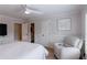 This bedroom features a plush recliner, a comfortable bed, and white trim at 1021 Wetherby Way, Alpharetta, GA 30022