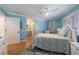 Charming bedroom featuring soothing blue walls, ceiling fan and a light-filled en-suite bathroom at 1021 Wetherby Way, Alpharetta, GA 30022
