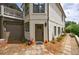 Exterior view with a side entrance, garage, well-maintained landscaping, and stepping stone walkway at 1021 Wetherby Way, Alpharetta, GA 30022