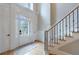 Elegant foyer with a staircase, white paneled walls, and plenty of natural light at 1021 Wetherby Way, Alpharetta, GA 30022