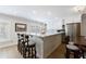 Bright kitchen featuring a large island with bar seating, stainless steel appliances, and white cabinetry at 1021 Wetherby Way, Alpharetta, GA 30022