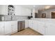 Bright kitchen featuring stainless steel appliances, granite countertops, and white cabinetry at 1021 Wetherby Way, Alpharetta, GA 30022