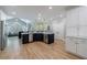 Bright, open kitchen with stainless steel appliances, navy island and cabinetry, and hardwood floors at 1021 Wetherby Way, Alpharetta, GA 30022