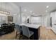 Gourmet kitchen with a large center island, bar seating, and plenty of white custom cabinetry at 1021 Wetherby Way, Alpharetta, GA 30022