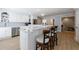 Bright kitchen featuring a large island with bar seating, stainless steel appliances, and white cabinetry at 1021 Wetherby Way, Alpharetta, GA 30022