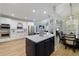 This kitchen features a large island, stainless steel appliances and pristine white cabinets at 1021 Wetherby Way, Alpharetta, GA 30022