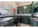 Well-organized laundry room with green cabinets, sink, and modern washer and dryer at 1021 Wetherby Way, Alpharetta, GA 30022