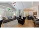 Bright living room flowing into dining area with large windows and comfortable seating at 1021 Wetherby Way, Alpharetta, GA 30022
