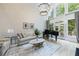 Spacious living room featuring a grand piano, hardwood floors, and large windows at 1021 Wetherby Way, Alpharetta, GA 30022