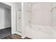 Bathroom featuring a tub, shower with a glass door, and a view of a walk-in closet at 1954 Durwood Ln, Duluth, GA 30096