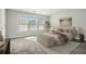 Bright bedroom featuring carpet floors, a stylish bench, and ample natural light from the large windows at 1954 Durwood Ln, Duluth, GA 30096