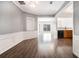 Spacious dining room with modern flooring, wainscoting, and views of the kitchen at 1954 Durwood Ln, Duluth, GA 30096