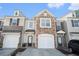 Charming townhome featuring a stone facade, attached garage, and inviting entryway at 1954 Durwood Ln, Duluth, GA 30096