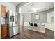 Open kitchen with stainless steel refrigerator and dining area access at 1954 Durwood Ln, Duluth, GA 30096