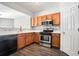 Well-lit kitchen with stainless appliances, modern finishes, and a sleek design at 1954 Durwood Ln, Duluth, GA 30096
