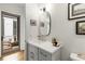 Well-lit bathroom boasts a stylish vanity, a distinctive mirror, and an open doorway to an outdoor patio at 219 Howell Se Dr # A, Atlanta, GA 30316