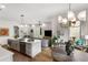Open concept living room features a kitchen island, hardwood floors, and modern light fixtures at 219 Howell Se Dr # A, Atlanta, GA 30316
