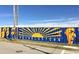 Brightly colored Reynoldstown mural showing various faces and a radiating sun at 219 Howell Se Dr # A, Atlanta, GA 30316