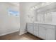 Bright bathroom with a vanity, mirror, and window providing natural light at 3181 Meadowstone Sw Ln, Atlanta, GA 30331