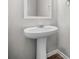 Bathroom featuring white pedestal sink, framed mirror, and modern fixtures at 3181 Meadowstone Sw Ln, Atlanta, GA 30331