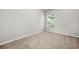 A carpeted bedroom showcasing a window view and neutral paint at 3181 Meadowstone Sw Ln, Atlanta, GA 30331