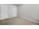 A carpeted bedroom showcasing a two white doors and neutral paint at 3181 Meadowstone Sw Ln, Atlanta, GA 30331