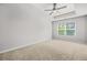 Carpeted bedroom with a ceiling fan, and window offering natural light at 3181 Meadowstone Sw Ln, Atlanta, GA 30331