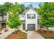 Charming townhome with a painted brick facade, well-manicured landscaping, and a one-car garage at 3181 Meadowstone Sw Ln, Atlanta, GA 30331