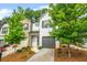 Charming townhome with a painted brick facade, well-manicured landscaping, and a one-car garage at 3181 Meadowstone Sw Ln, Atlanta, GA 30331