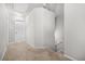 Well-lit hallway with neutral carpet, white walls, and access to multiple rooms at 3181 Meadowstone Sw Ln, Atlanta, GA 30331