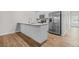 Modern kitchen featuring stainless steel appliances, white cabinets, granite countertops, and hardwood floors at 3181 Meadowstone Sw Ln, Atlanta, GA 30331