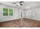 Bright living room featuring hardwood floors, ceiling fan, and natural light from a large window at 3181 Meadowstone Sw Ln, Atlanta, GA 30331
