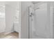 Modern bathroom shower with glass door, sleek fixtures, and convenient shelving at 3181 Meadowstone Sw Ln, Atlanta, GA 30331