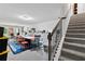 Finished basement with a large table, colorful chairs, and a convenient staircase, ideal for gatherings or hobbies at 3255 Morgan Rd, Buford, GA 30519