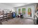 Finished basement area features a table, seating and a walkout to a backyard area with views of green trees at 3255 Morgan Rd, Buford, GA 30519
