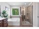 Bathroom features a glass enclosed shower, soaking tub and a window to the outside at 3255 Morgan Rd, Buford, GA 30519