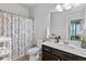 Bathroom features decorative shower curtain, white marble vanity top and dark wooden cabinets at 3255 Morgan Rd, Buford, GA 30519
