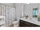 This bathroom features a vanity with granite countertops, a shower and decorative shower curtain at 3255 Morgan Rd, Buford, GA 30519