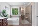 Bathroom with tub, separate shower, and dark wood vanity at 3255 Morgan Rd, Buford, GA 30519