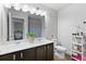 Well-lit bathroom with double sinks, sleek cabinetry, and a calming plant offering both style and functionality at 3255 Morgan Rd, Buford, GA 30519