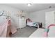 Cozy bedroom featuring whimsical wall decor, plush bedding and plenty of natural light at 3255 Morgan Rd, Buford, GA 30519