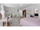 Bright bedroom featuring carpet, pink bed, desk and sitting area at 3255 Morgan Rd, Buford, GA 30519