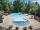 Expansive community pool with comfortable seating, umbrellas, and lush greenery, a resort-style oasis at 3255 Morgan Rd, Buford, GA 30519