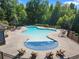 Wide overhead shot of the community pool with multiple lounge chairs and tables at 3255 Morgan Rd, Buford, GA 30519
