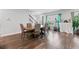 An open concept dining room boasts hardwood floors, lots of sunlight and neutral paint at 3255 Morgan Rd, Buford, GA 30519